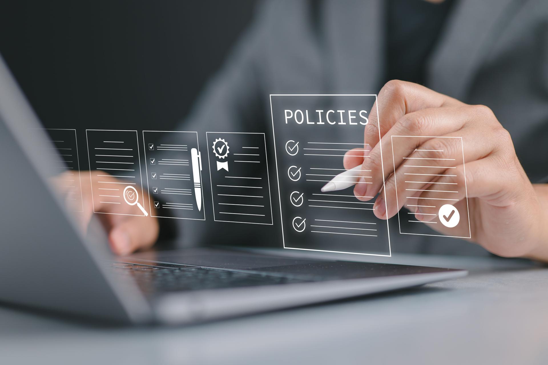 Policy documentation and compliance concept. Businessman reviews digital document Policies with icons, checklists, certifications, and financial detail. Policy management, regulatory compliance,