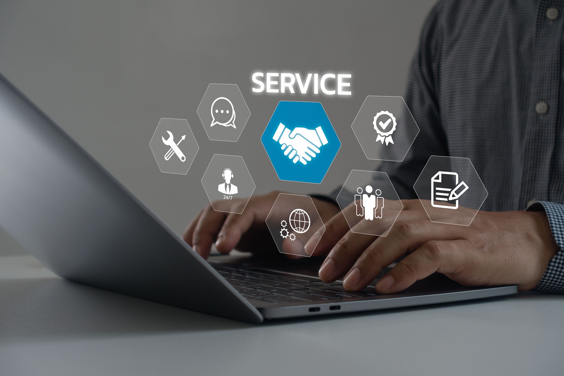 Technical support operator with virtual screen icon working on laptop computer. Help desk IT support call center online technology. Customer service and business warranty quality assurance concept.