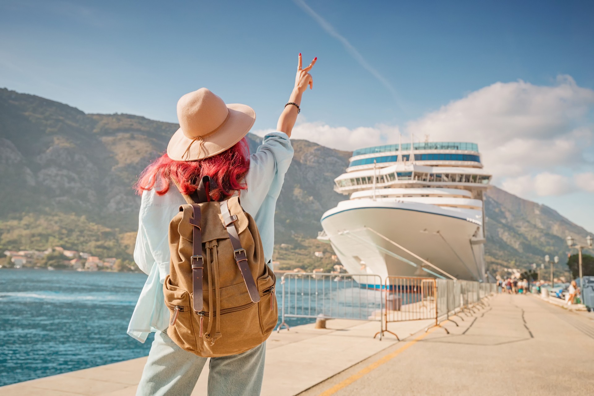 Tourist gesturing near cruise ship at Kotor bay, Montenegro