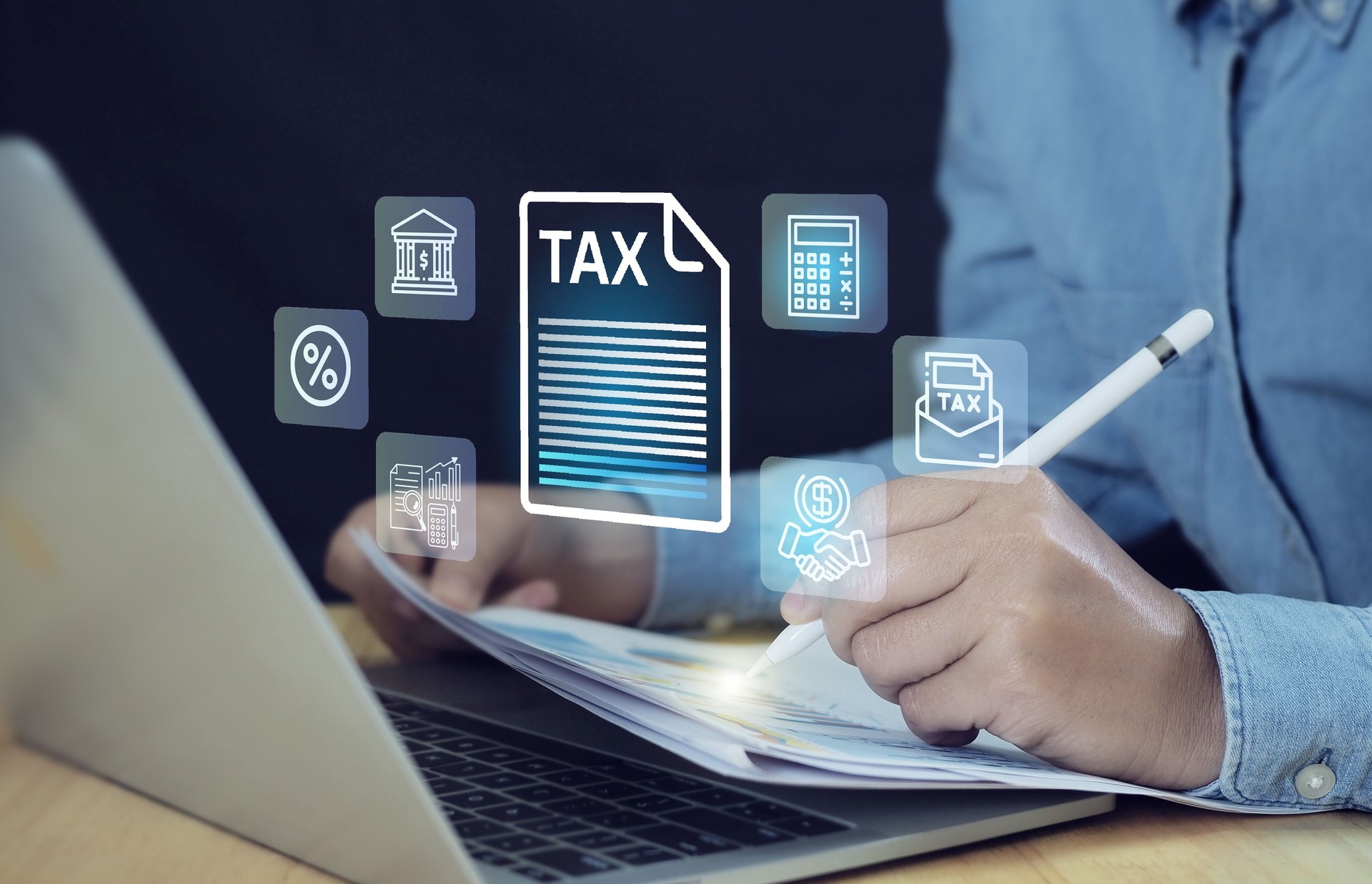 Tax and Vat concept. Government, state taxes concept. Businesman using calculator and laptop to complete Individual income tax return form online for tax payment. Data analysis, financial research.